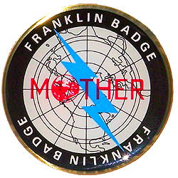 A photograph of the real-life Franklin Badge packaged with Mother 3's deluxe box. From WikiBound.