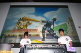 A picture from the 2007 Tokyo Game Show. Mr. Saturn can be seen being hit by Snake's Home-Run Bat.