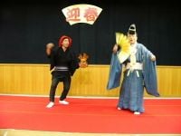 Manzai performed in real life. The fan can be seen to the right; its design is different from that found in the games, but the overall concept is identical.