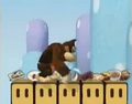 Donkey Kong stands on a row of five Rotating Blocks.